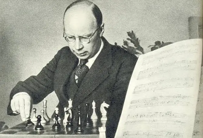 Picture of Sergei Prokofiev playing chess with a music sheet on the front.